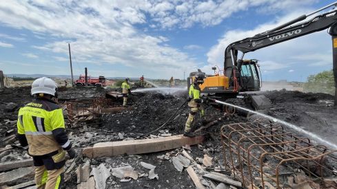 Los bomberos de la Diputación trabajan en la extinción total del incendio en la nave de La Bañeza tras más de un mes activo